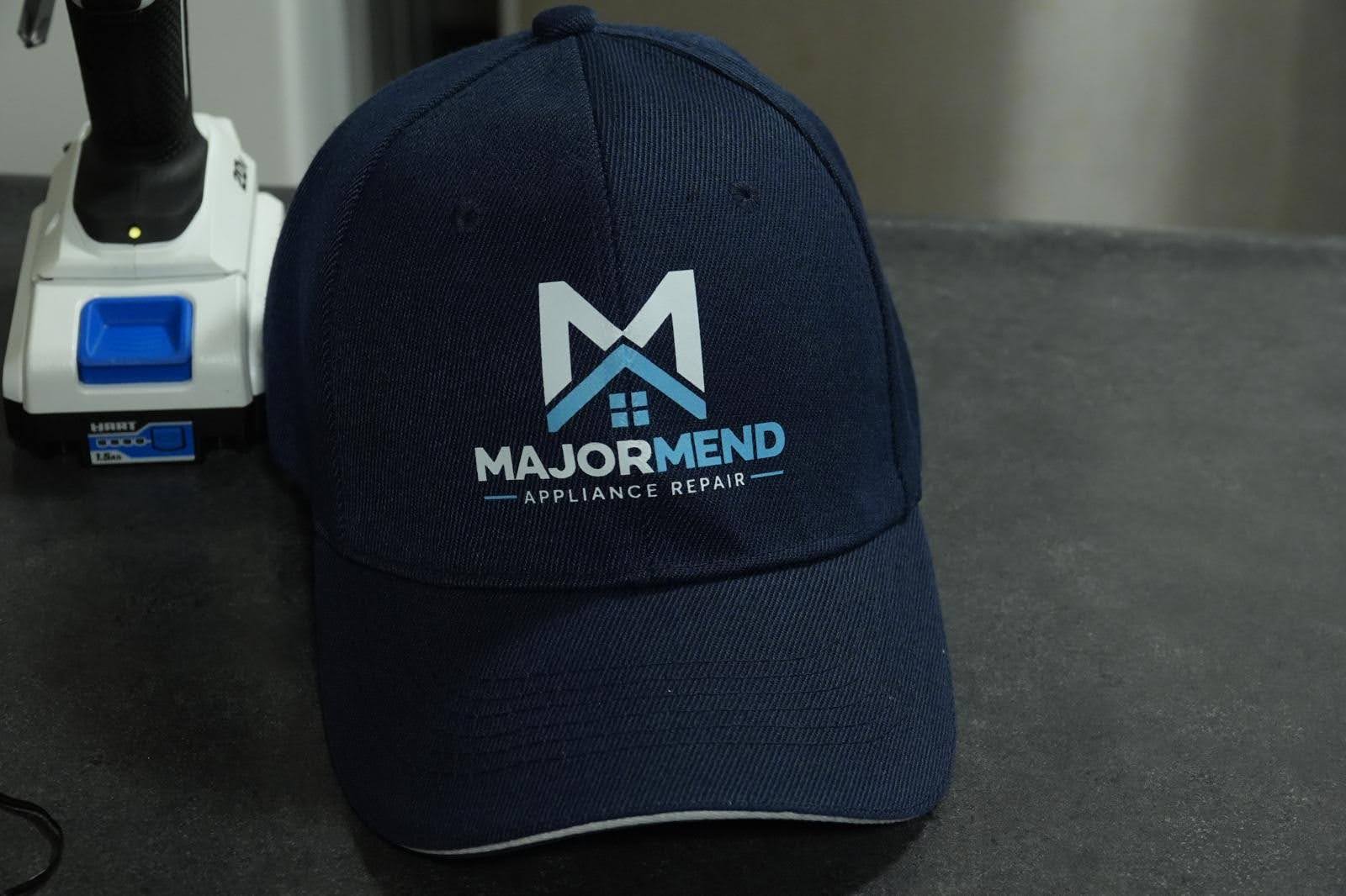 MajorMend branded cap and a cordless drill
