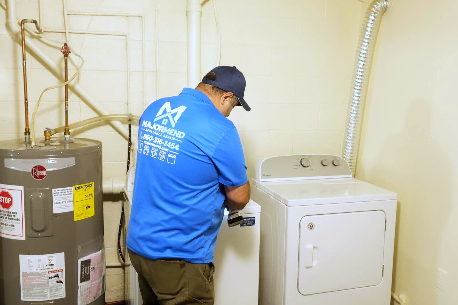 MajorMend technician inspecting a washing machine